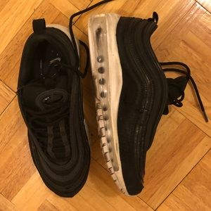 Black Nike Air Max 97s.